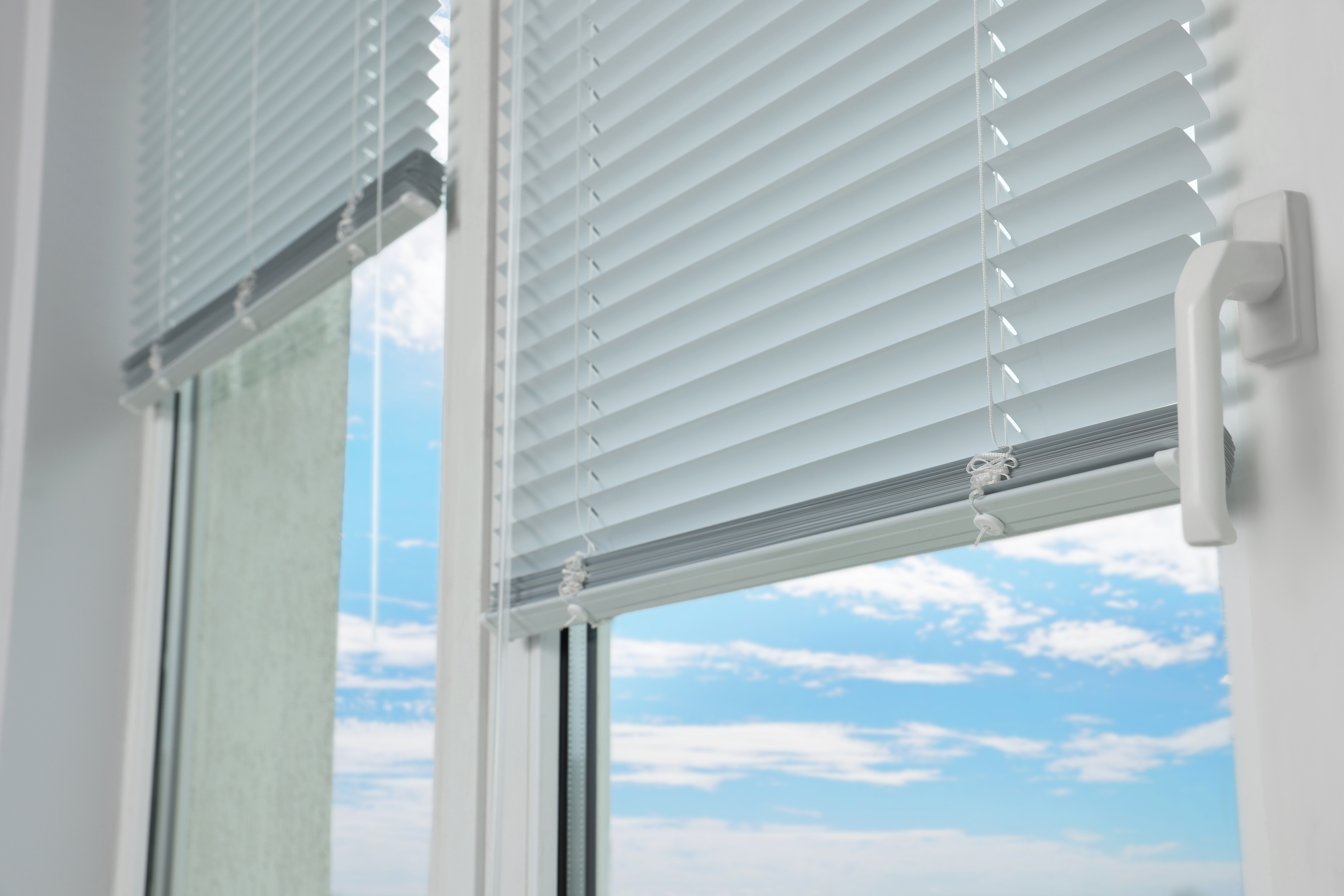 Stylish window with horizontal blinds, closeup view