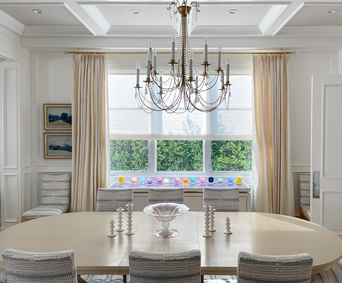Dining room with chandelier and draped windows